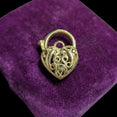 The Vintage Vault vintage 9K yellow gold heart padlock pendant featuring intricate open work filigree detailing.
