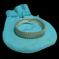 The Vintage Vault Tiffany & Co sterling silver Somerset mesh bangle bracelet resting on a signature blue pouch.